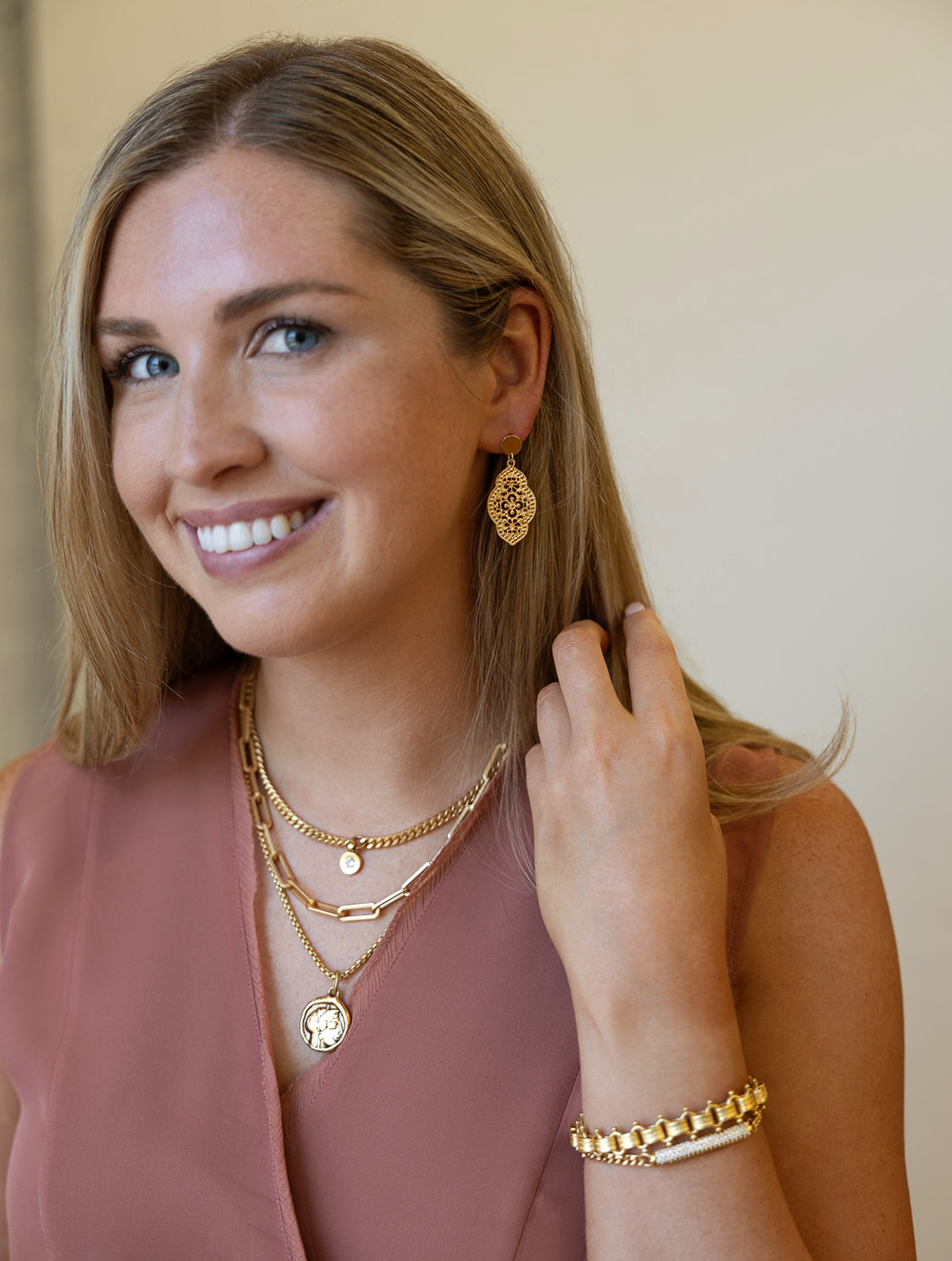 An oval lace earring on a gold post