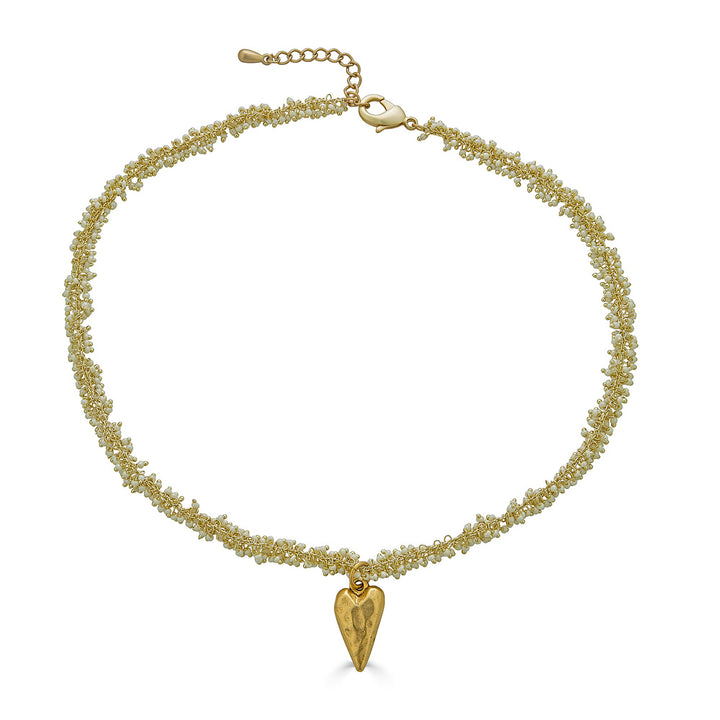 A seed pearl drizzle necklace with a hammered heart pendant