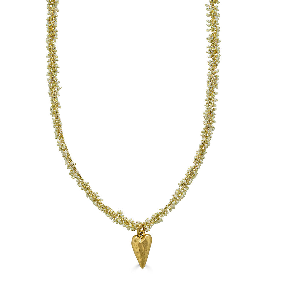 A seed pearl drizzle necklace with a hammered heart pendant