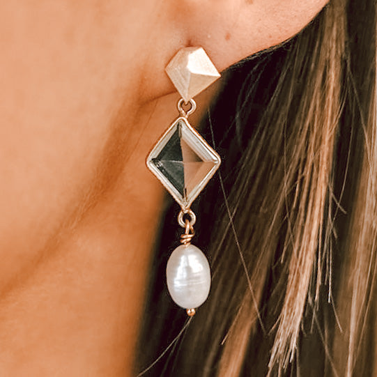 an asymmetrical quartz earring with a pearl dangle