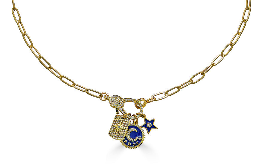A matte gold paperclip chain necklace with a blue moon, north star, and circle charm with a pave lobster claw.
