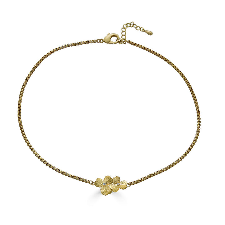 a bar necklace with a gold clover connector