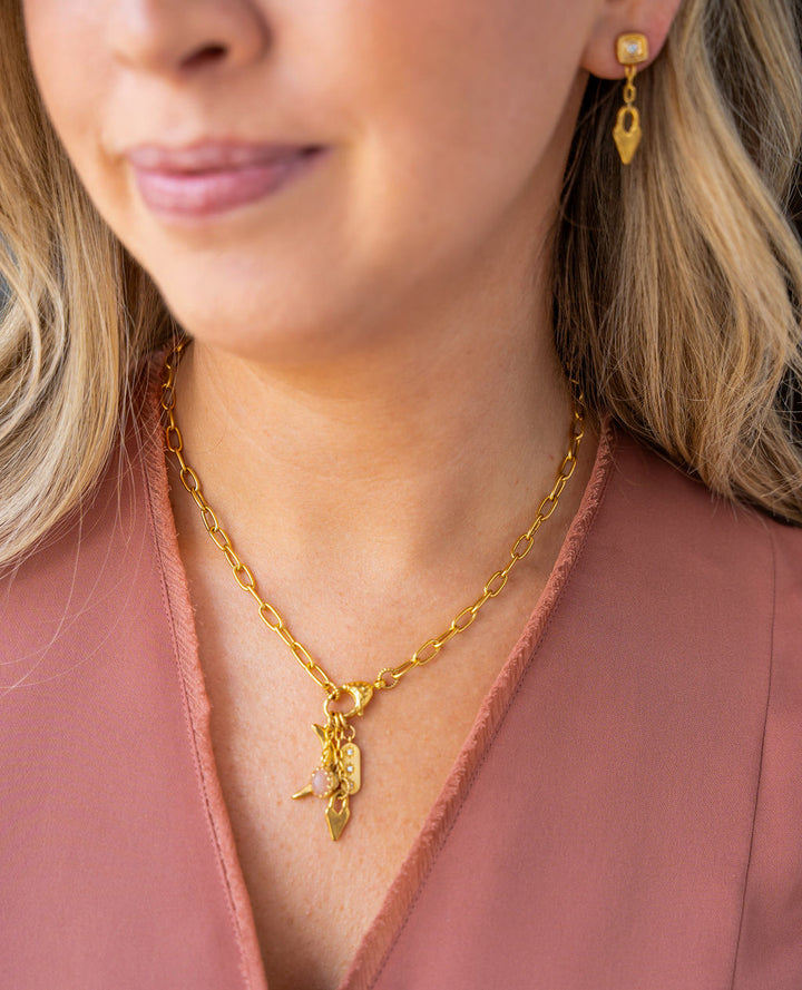 Gold dangle earrings with sculpted heart charms, chain link drop, and square stud tops with CZ accents.