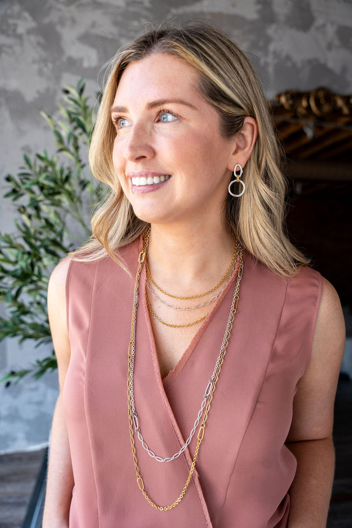 Long gold chain necklace with delicate textured links, designed for layering or doubling