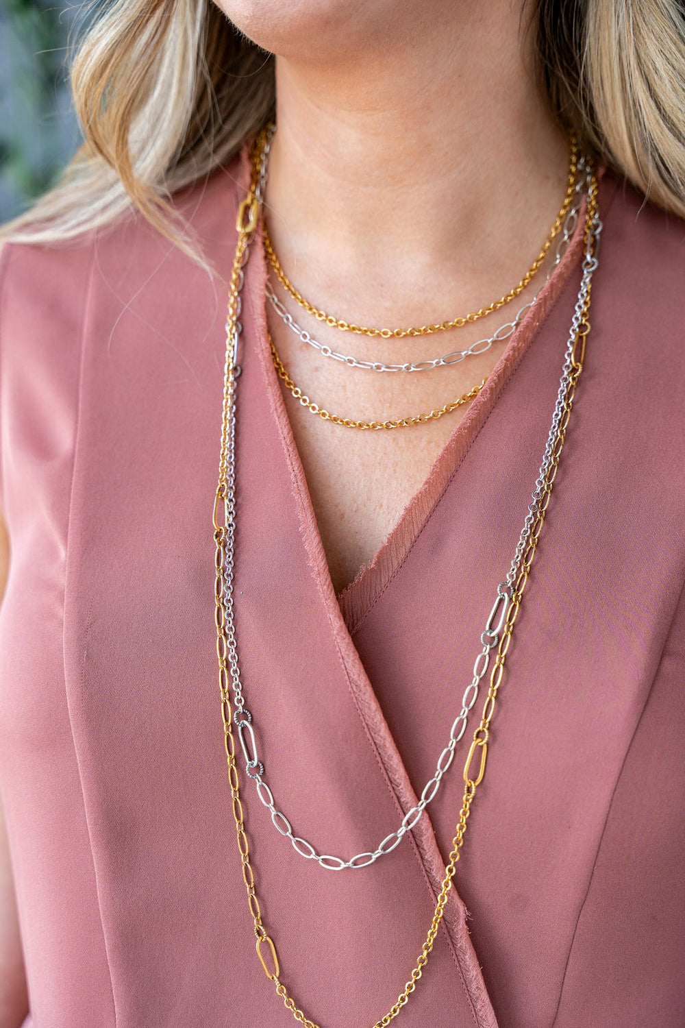 Long silver chain necklace with mixed delicate links, designed for layering or wearing doubled