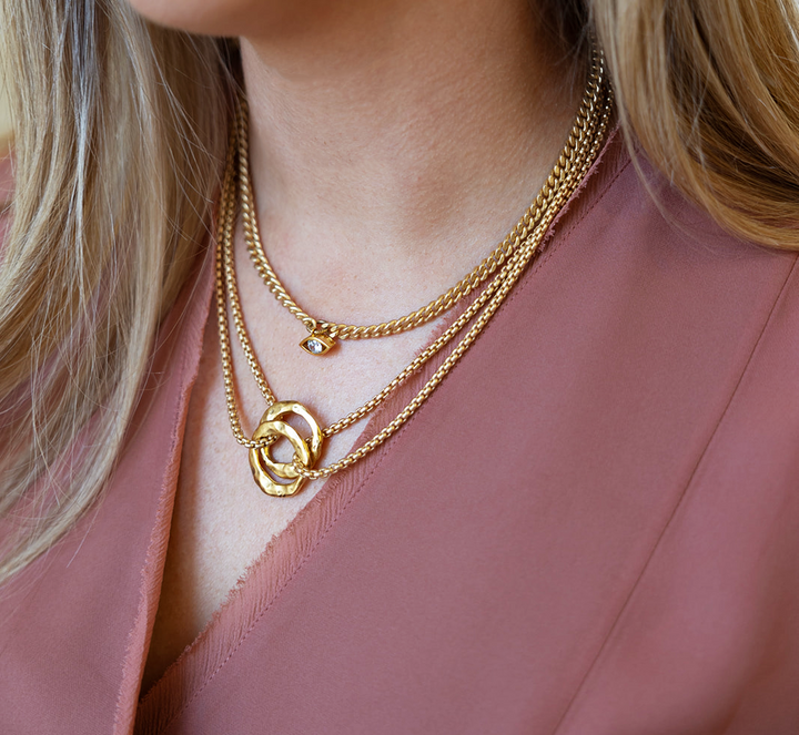 a matte gold two strand necklace with two hammered circles