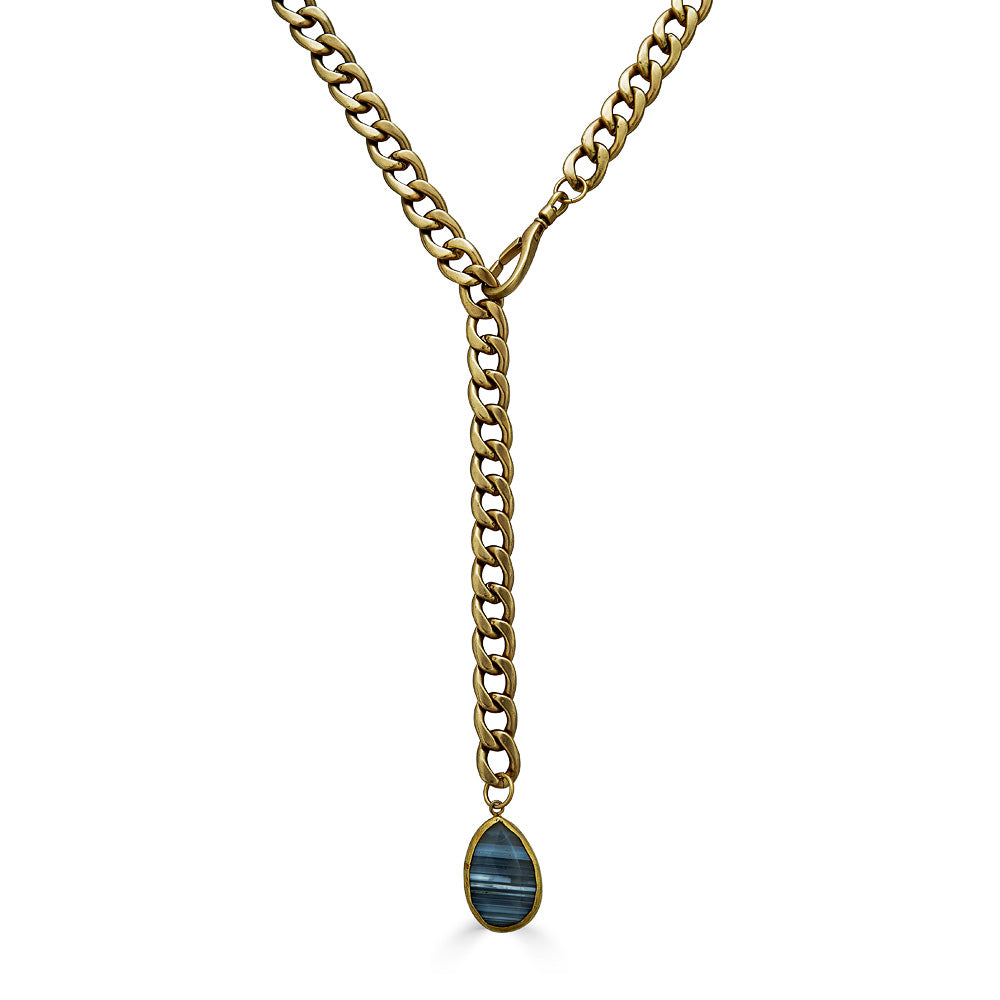 A matte gold lariat with an agate pendant