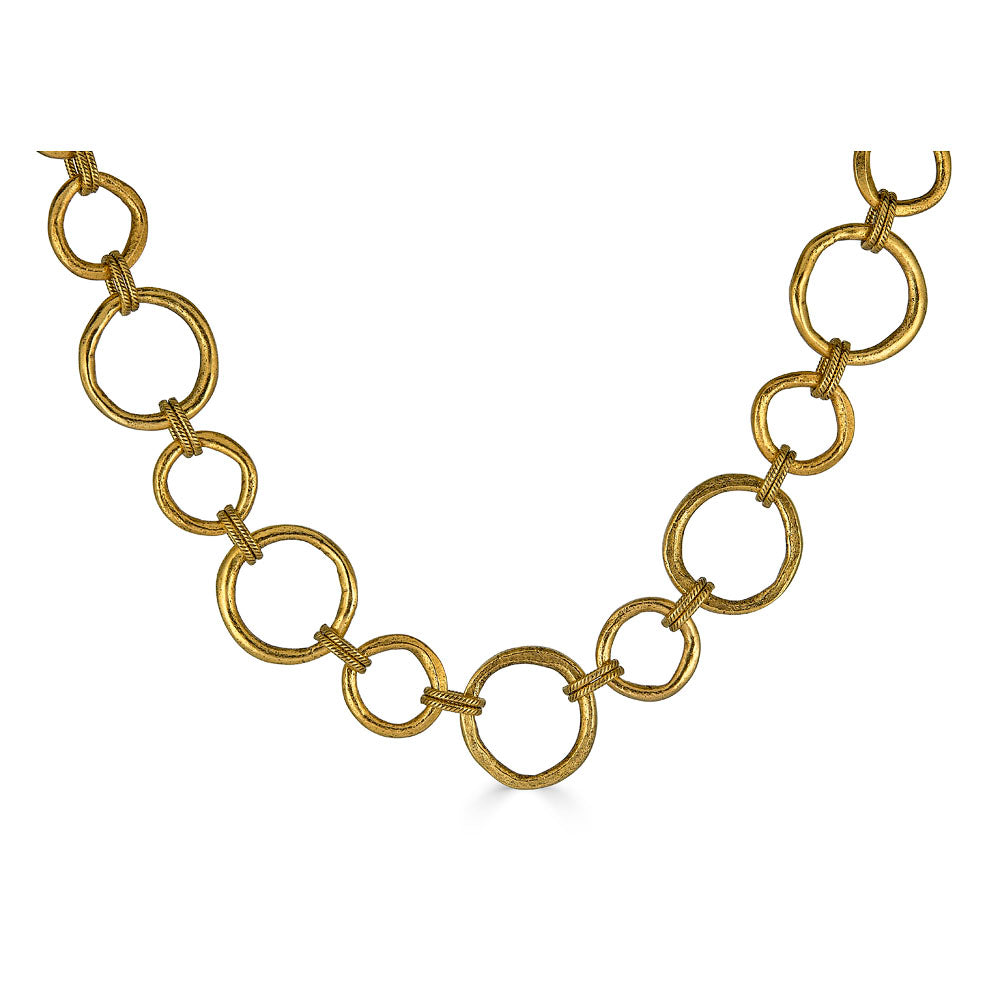 Matte gold sculpted circle necklace with textured round links and toggle clasp, styled three ways including lariat.