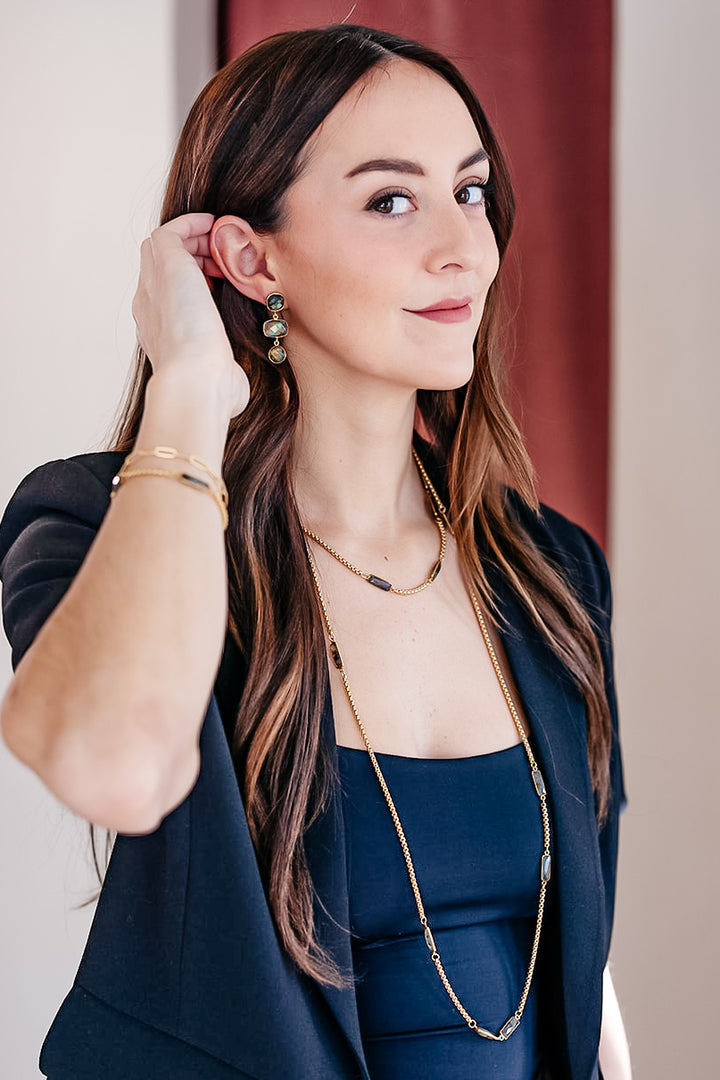A model wearing A box chain necklace with baguette cut labradorite gemstones.