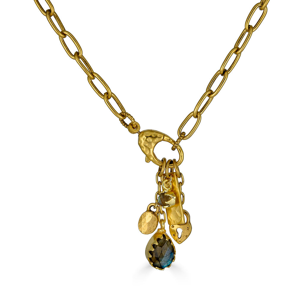 Gold chain necklace with a front clasp and dangling charms including a teardrop labradorite and textured gold talismans.
