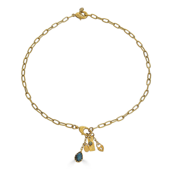 Gold chain necklace with a front clasp and dangling charms including a teardrop labradorite and textured gold talismans.