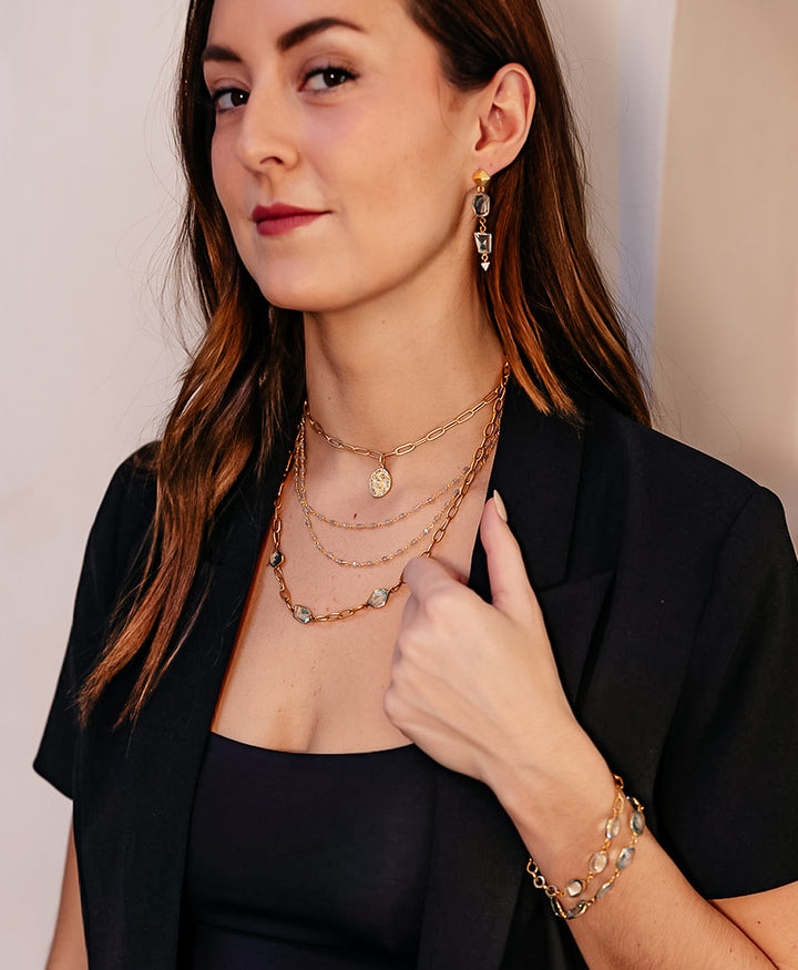 A model wearing A paperclip chain with fancy cut asymmetrical quartz crystals