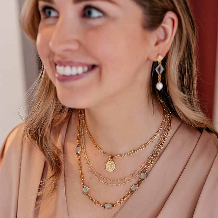 A model wearing A paperclip chain with fancy cut asymmetrical quartz crystals
