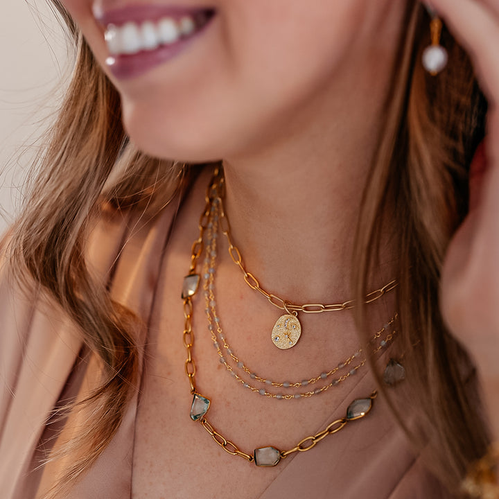 A model wearing A paperclip chain with fancy cut asymmetrical quartz crystals