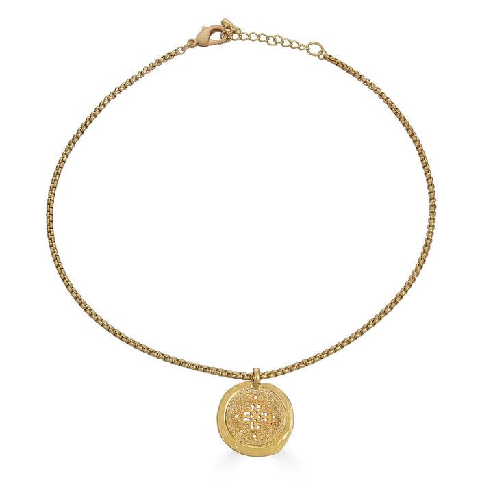 Matte gold coin necklace with filigree-etched round pendant on a rounded box chain.