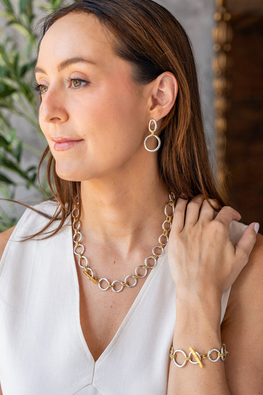 Mixed metal earrings with silver sculpted circles, soft gold oval tops, and rope-textured gold connector rings.