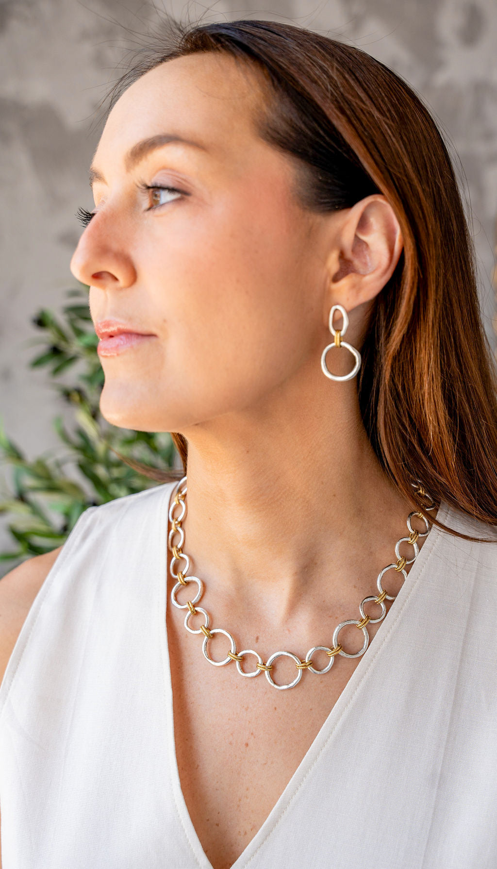 Mixed metal earrings with silver sculpted circles, soft gold oval tops, and rope-textured gold connector rings.