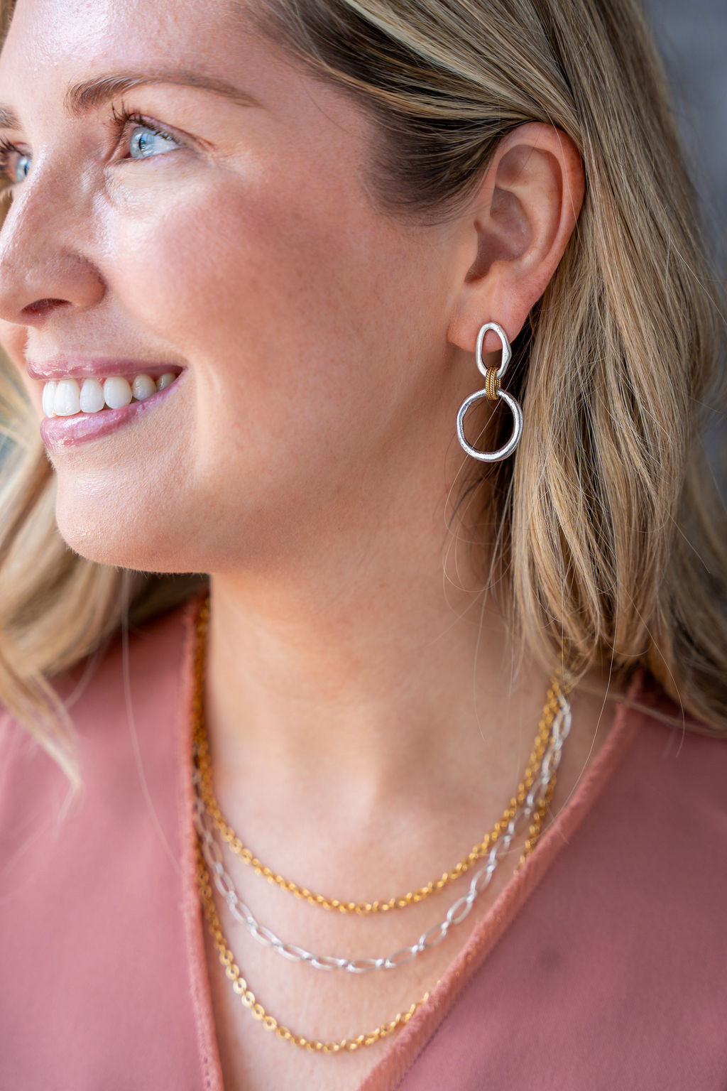 Mixed metal three-strand necklace with gold and silver-toned chains and adjustable clasp