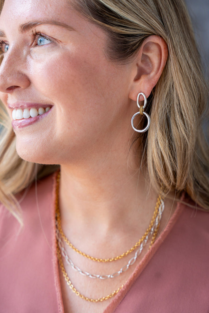 Mixed metal three-strand necklace with gold and silver-toned chains and adjustable clasp