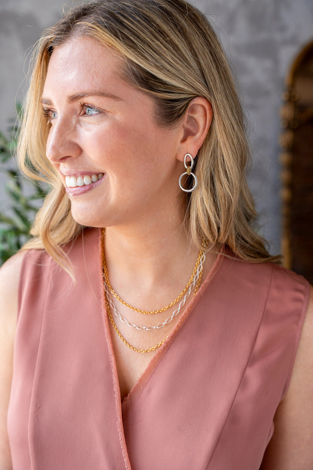 Mixed metal three-strand necklace with gold and silver-toned chains and adjustable clasp