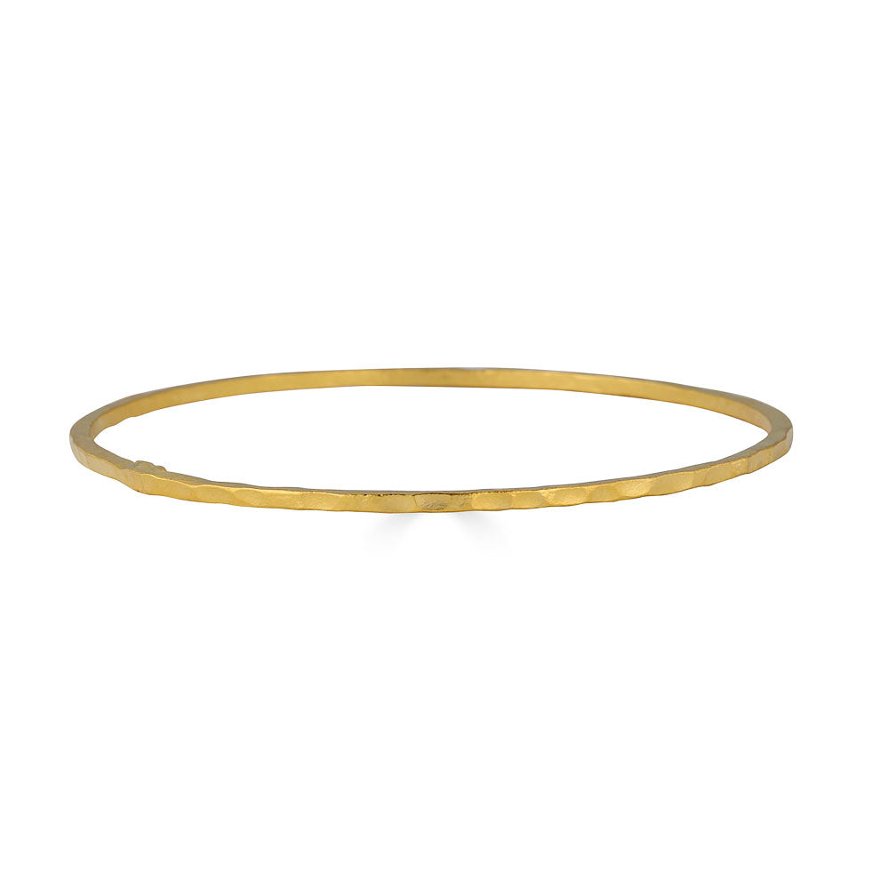 Slim gold bangle bracelet with a hammered finish.