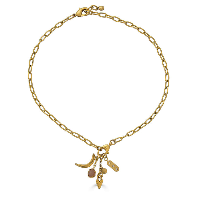 Gold necklace featuring a peach moonstone drop and charm cluster with crescent moon and heart details.