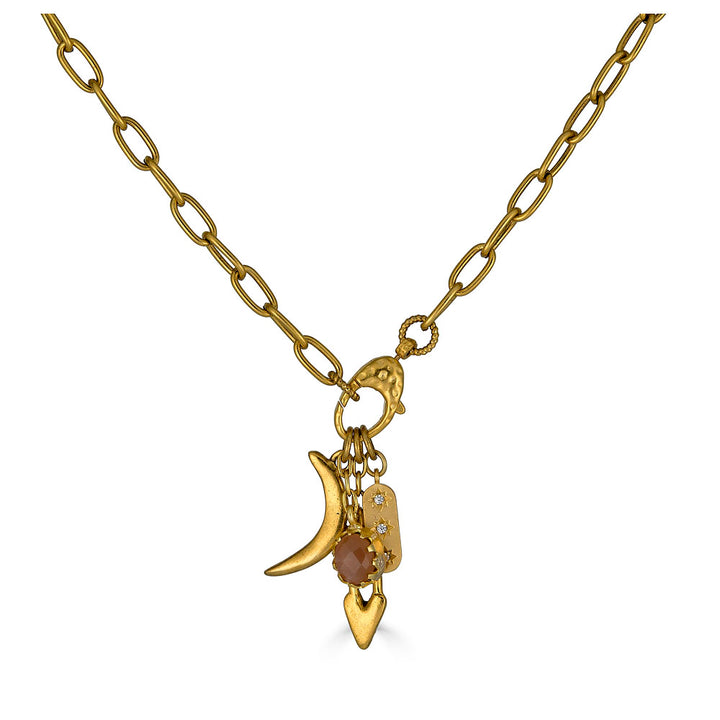 Gold necklace featuring a peach moonstone drop and charm cluster with crescent moon and heart details.