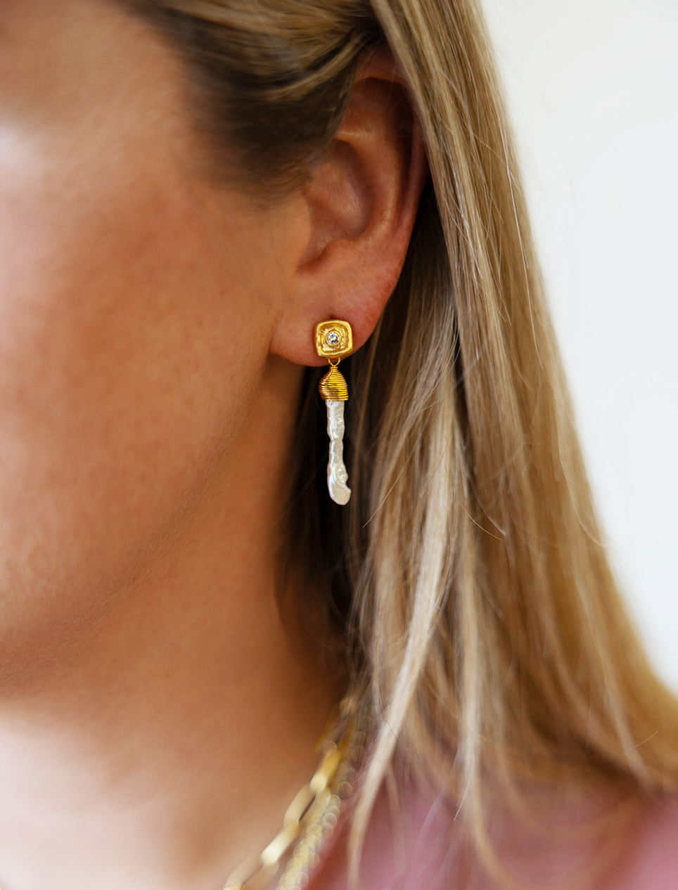 A baroque pearl shard on a crystal post