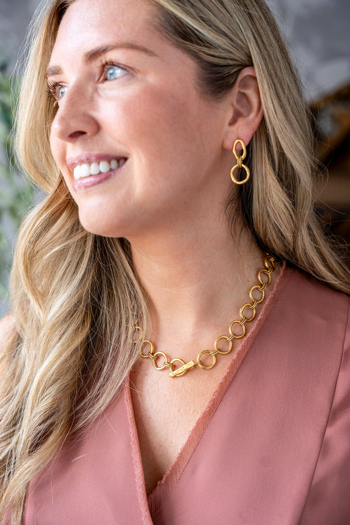 Matte gold sculpted circle necklace with textured round links and toggle clasp, styled three ways including lariat.