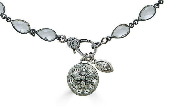 A crystal chainlink necklace with bee and crystal charm pendants and a pave clasp.