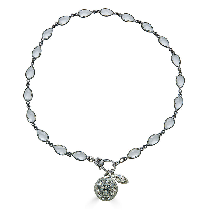A crystal chainlink necklace with bee and crystal charm pendants and a pave clasp.