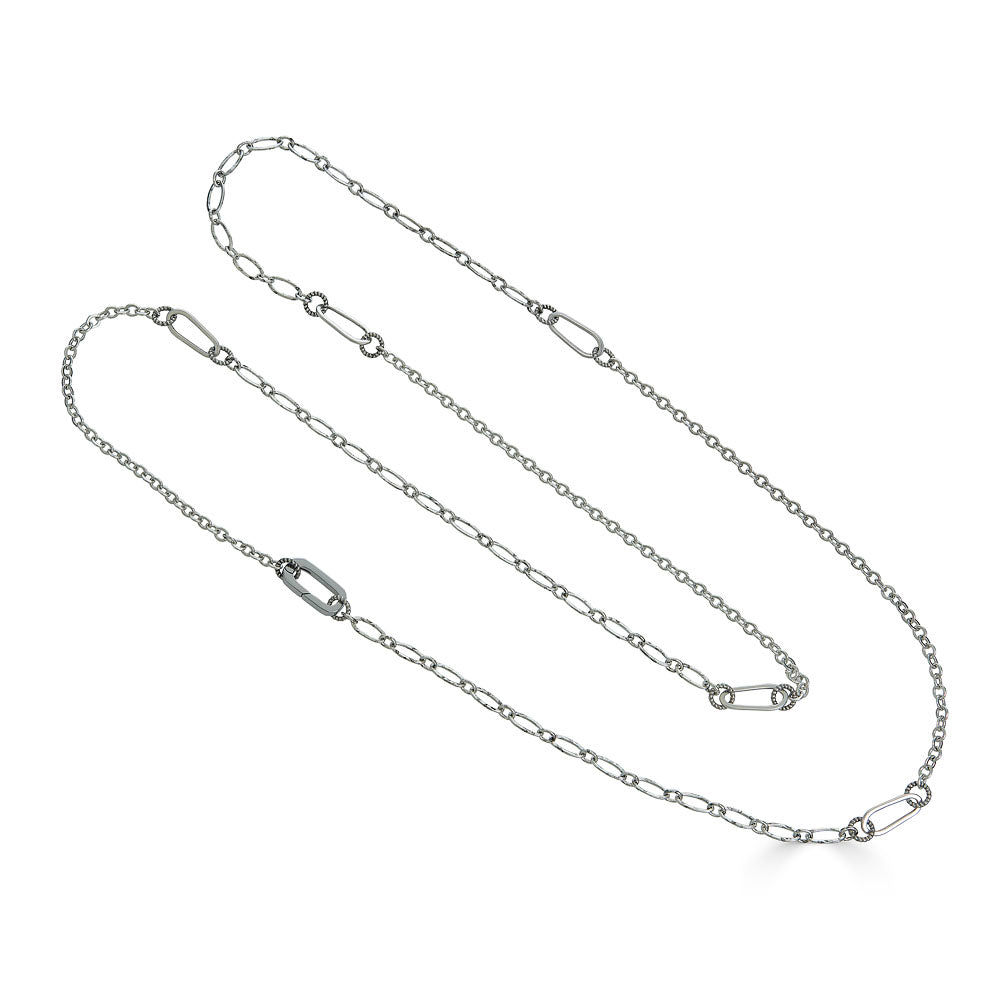 Long silver chain necklace with mixed delicate links, designed for layering or wearing doubled.