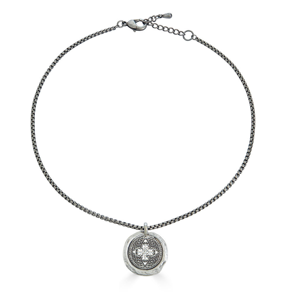 Antique silver necklace with round filigree coin pendant and rounded box chain.