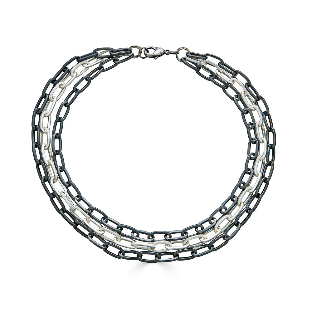 A three strand matte silver paperclip chain necklace.
