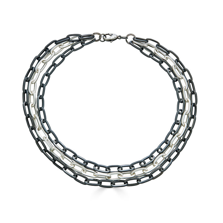 A three strand matte silver paperclip chain necklace.