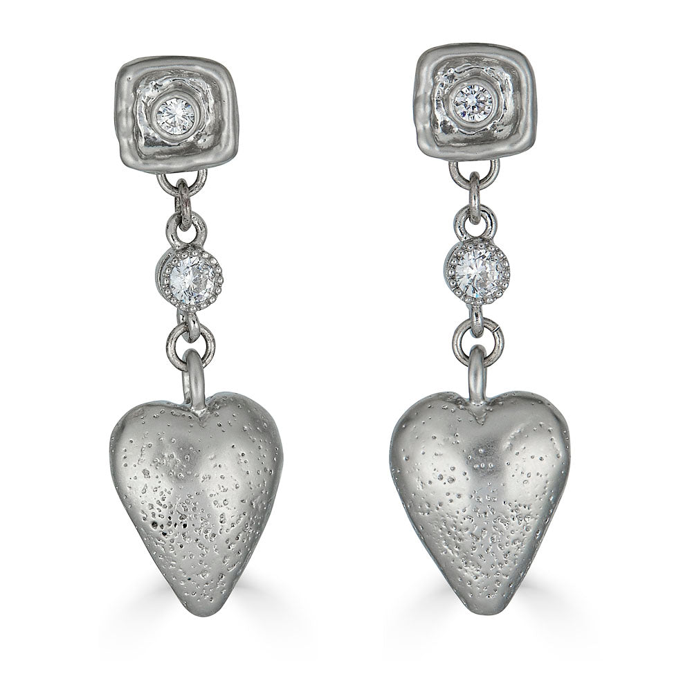 Silver drop earrings with textured puffed hearts and two bezel-set CZ stones on each earring.