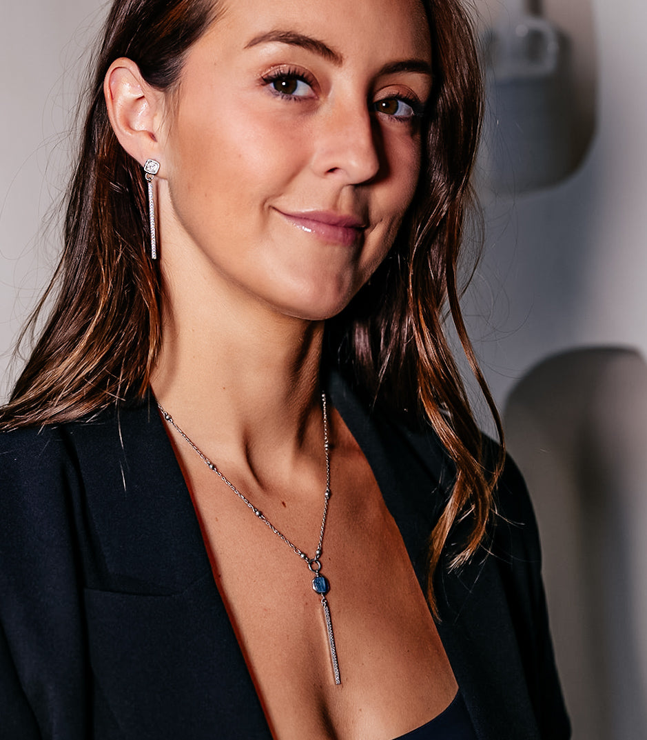 a model wearing a silver kyanite y necklace