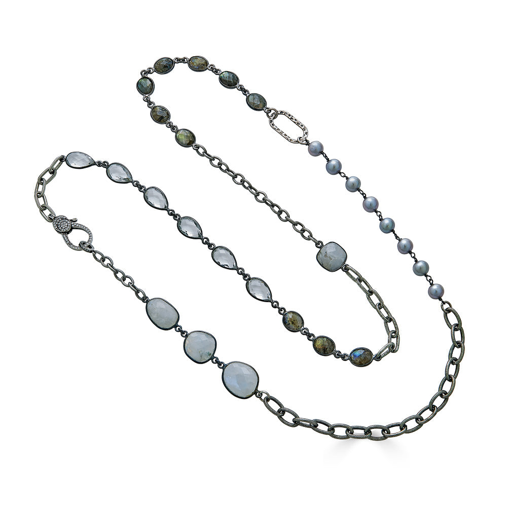A silver mixed chain and gemstone necklace, with moonstone, labradorite, crystal, and pearl details.