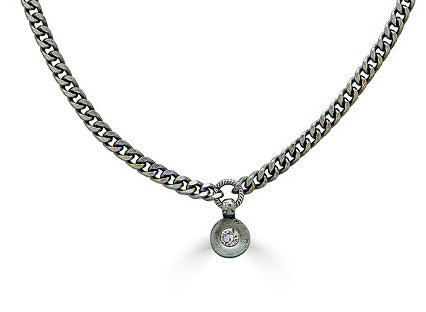 A delicate silver necklace with a small modern crystal pendant.