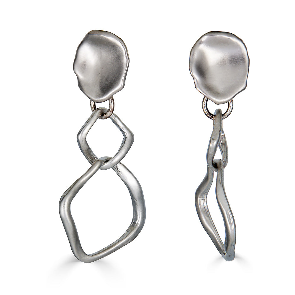 A matte silver dangle earring with nested square detail on a lotus leaf post.
