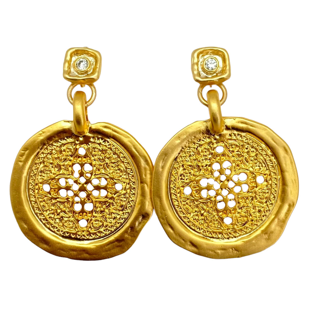 A hammered filagree gold coin earring on a square crystal post