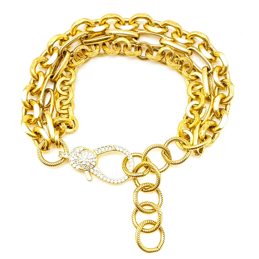 A three strand gold bracelet with pave lobster clasp.