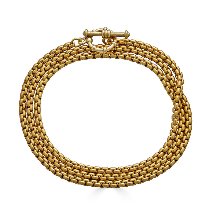 A gold venetian box chain lariat necklace.