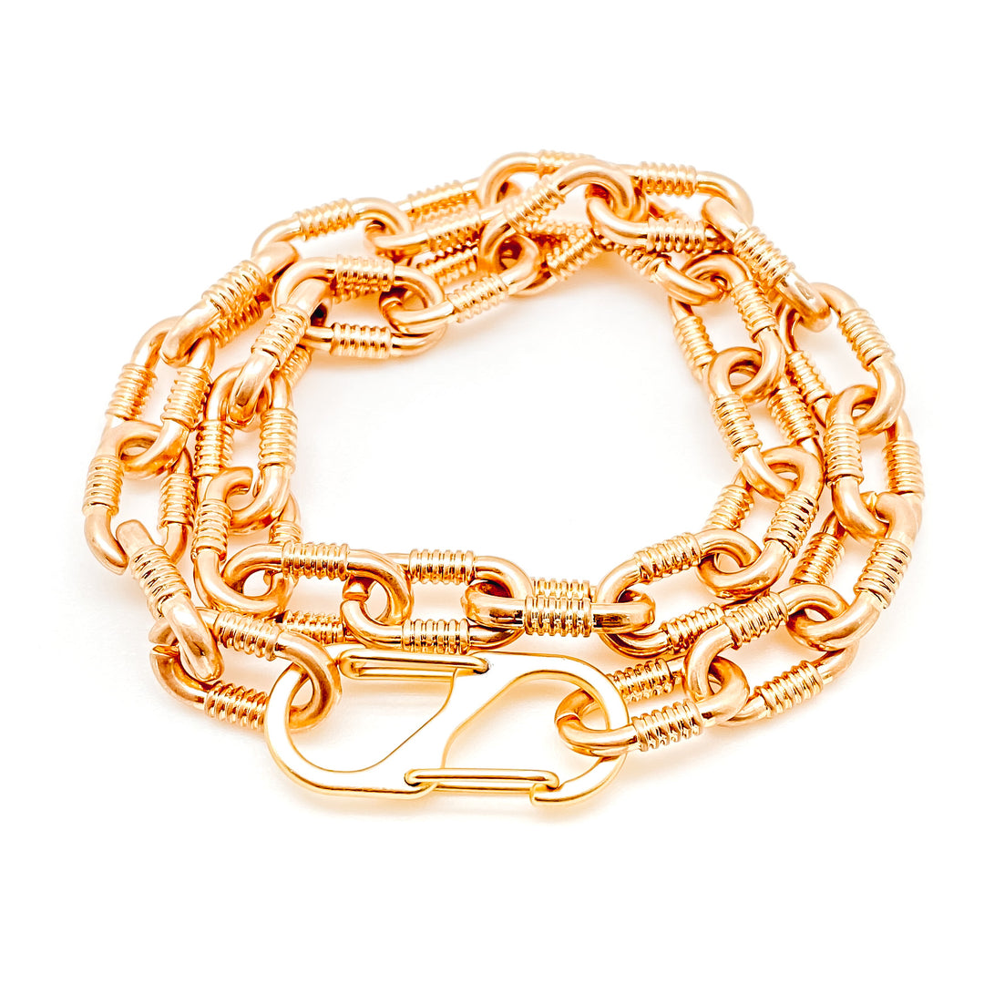 A matte gold, double wrap chunky chainlink bracelet with a snap clasp.