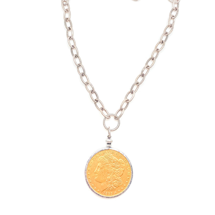 A vintage gold coin pendant necklace with silver chain.