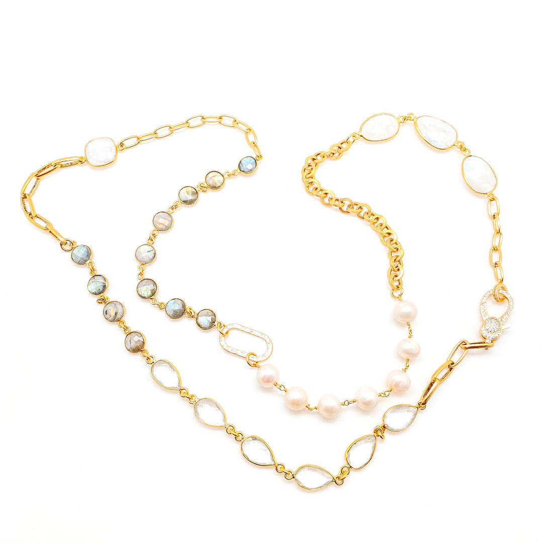 A gold mixed gemstone necklace with moonstones, labradorite, crystals, and pearls.