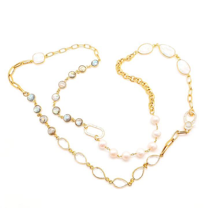 A gold mixed gemstone necklace with moonstones, labradorite, crystals, and pearls.