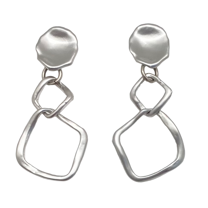 A matte silver dangle earring with nested square detail on a lotus leaf post.