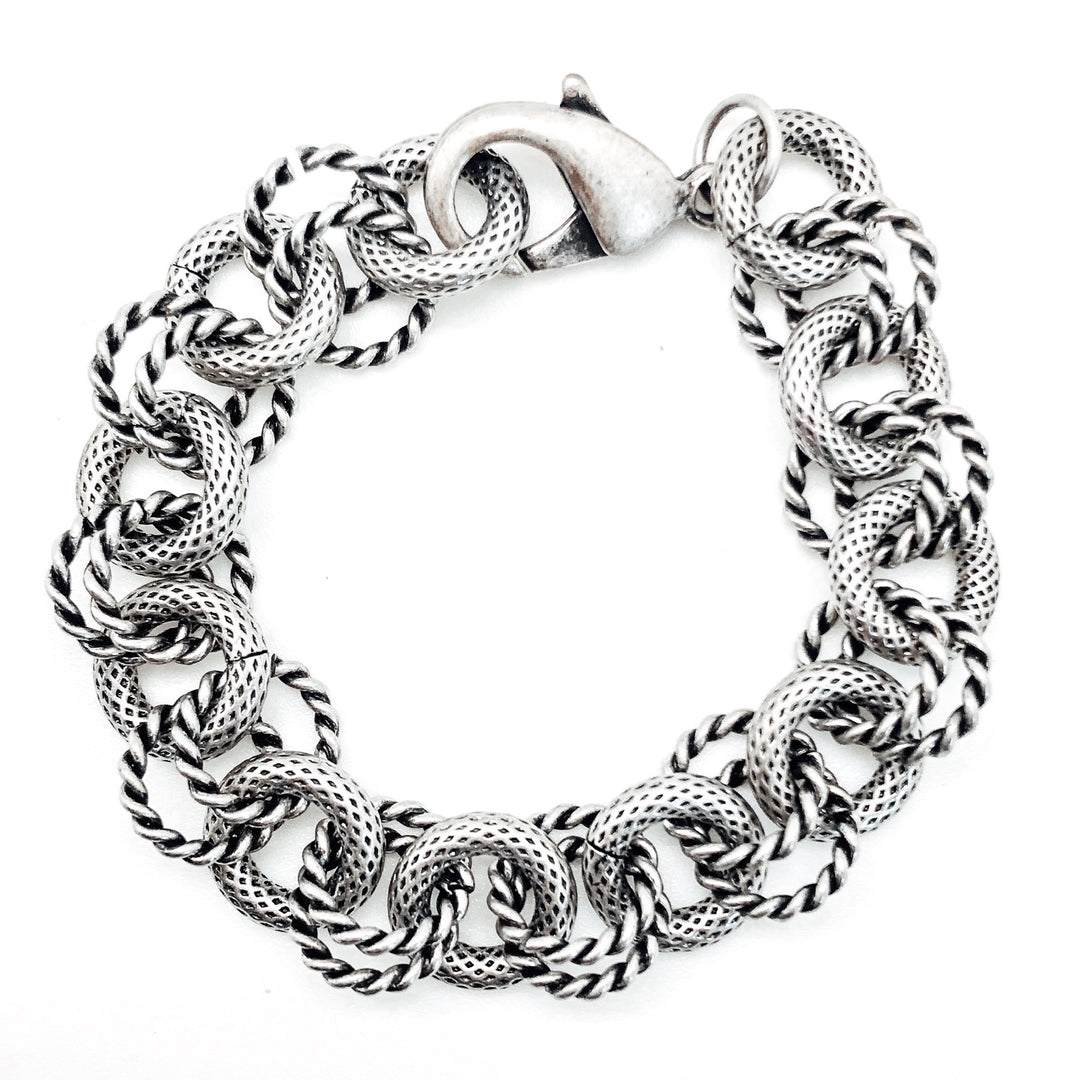 A silver round chunky chain bracelet with textured circle links.