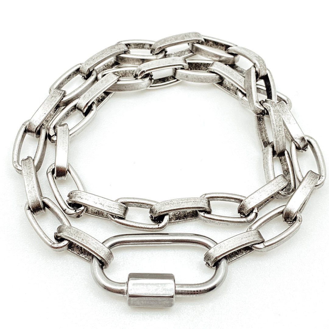 A chunky silver paperclip double wrap bracelet-necklace with carabiner link.